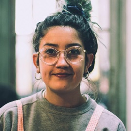 A woman with glasses and an updo